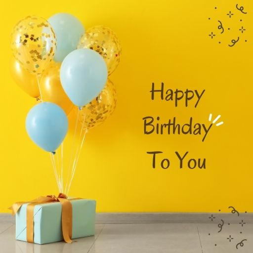 Happy Birthday image with blue and gold balloons, a gift box, and confetti on a yellow background.