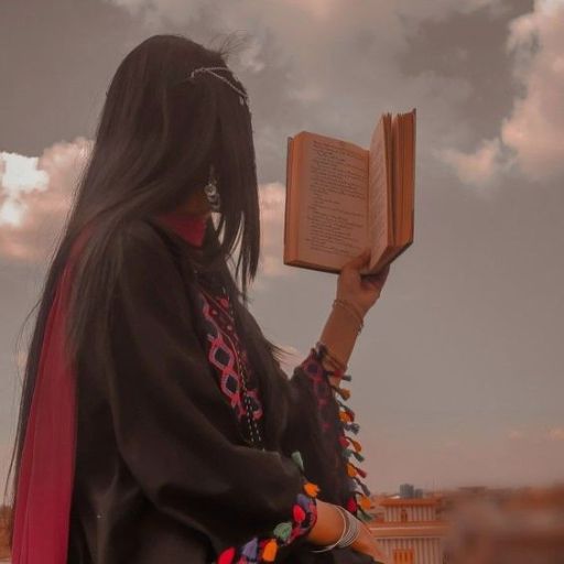 a woman with long hair holding a book