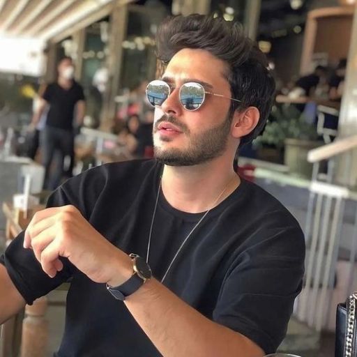 a man wearing sunglasses sitting at a table