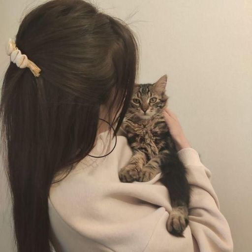 a woman holding a cat in her arms