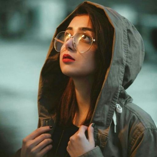 a woman wearing glasses and a hoodie