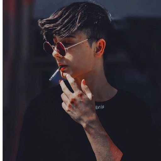 a man smoking a cigarette in a black shirt