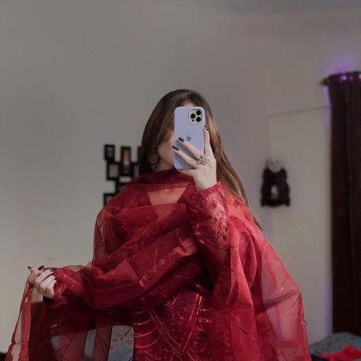 a woman in a red dress taking a selfie