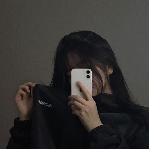 a woman taking a picture of herself with her phone