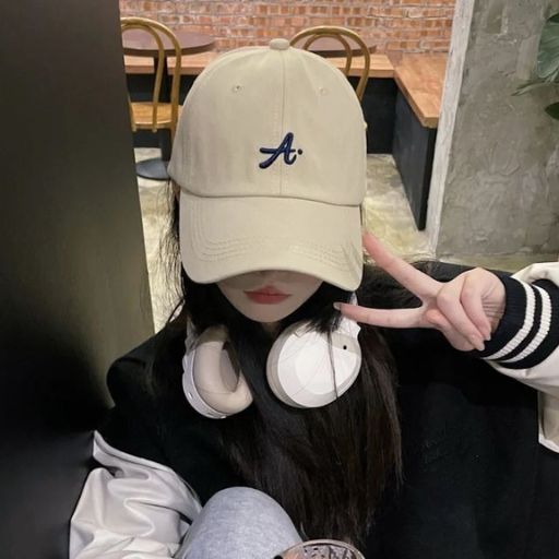 a girl wearing headphones and a baseball cap