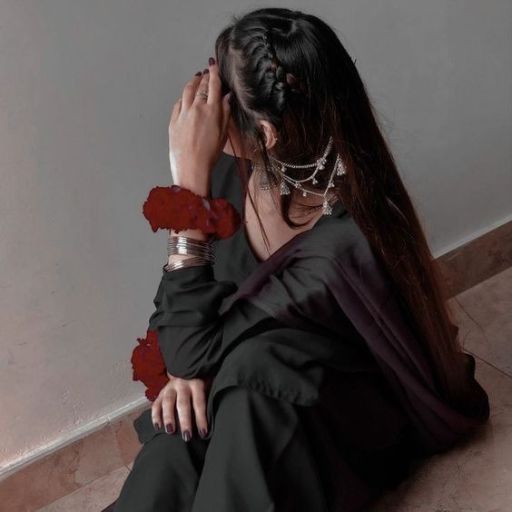 a woman with long hair sitting on the floor