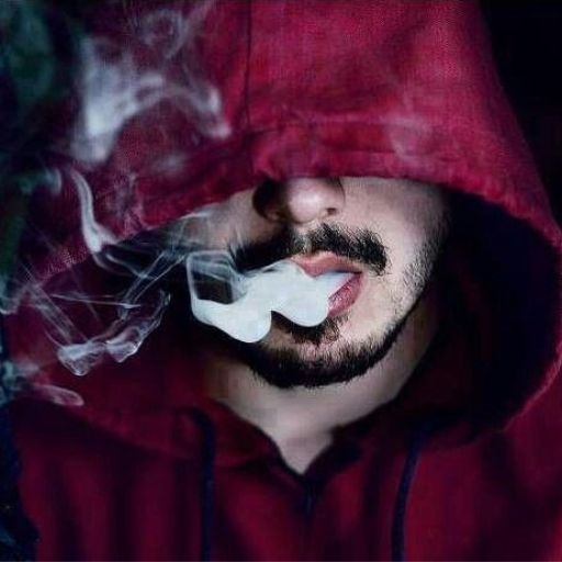 a man in a red hoodie smoking a cigarette