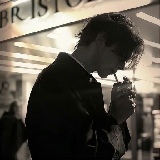 a man smoking a cigarette in front of a store