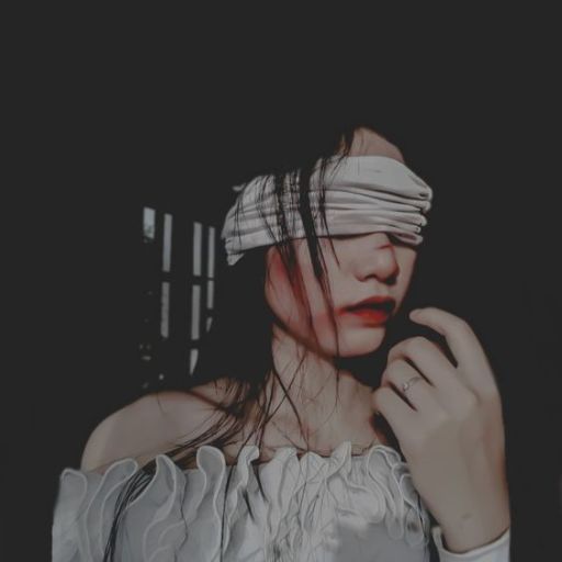 a woman with a blindfold on her face