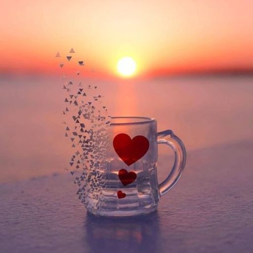 A transparent mug with heart shapes, shattering into triangles against a sunset background