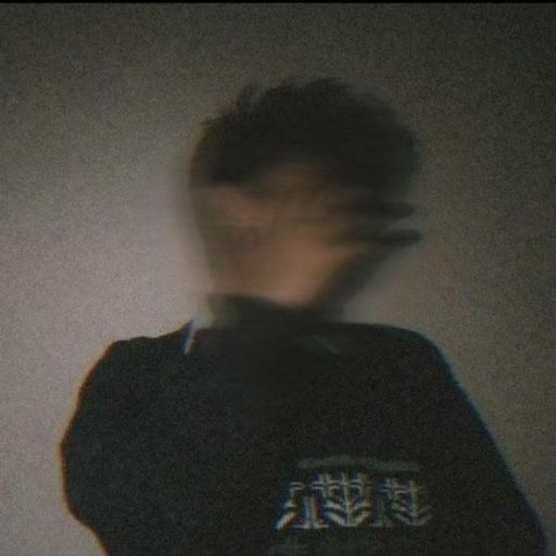 a blurry image of a man in a sweater