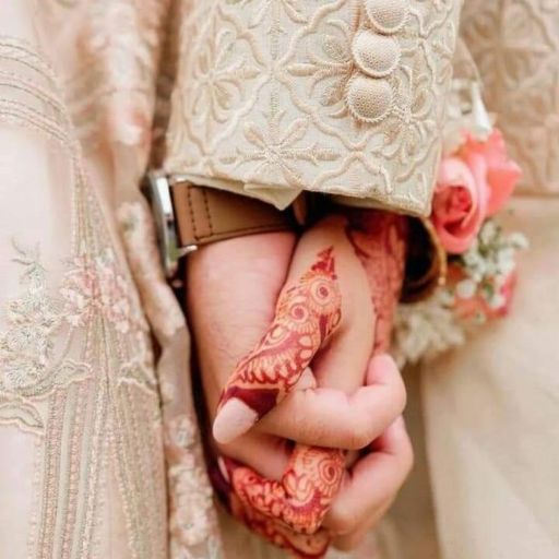 a close up of a person holding a wedding ring