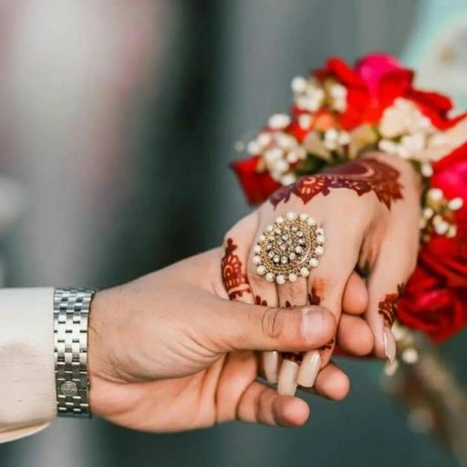 a close up of a person holding another person's hand