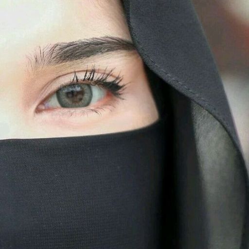 a close up of a person wearing a black veil