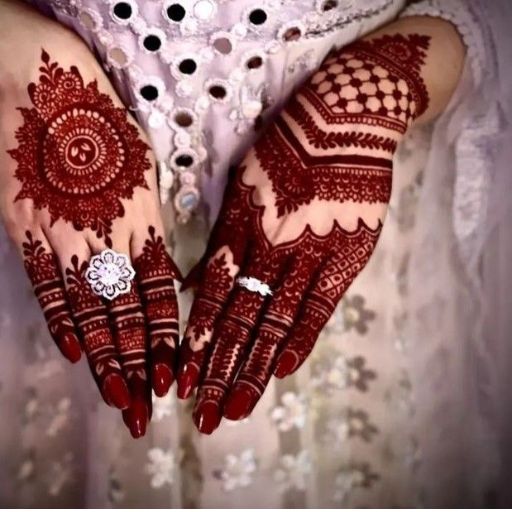 a close up of a woman's hands with hennap