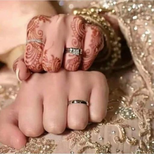 a couple holding hands with their wedding rings on their fingers