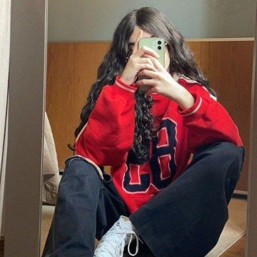 a girl taking a picture of herself in a mirror