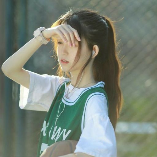 a girl with long hair wearing a green and white shirt