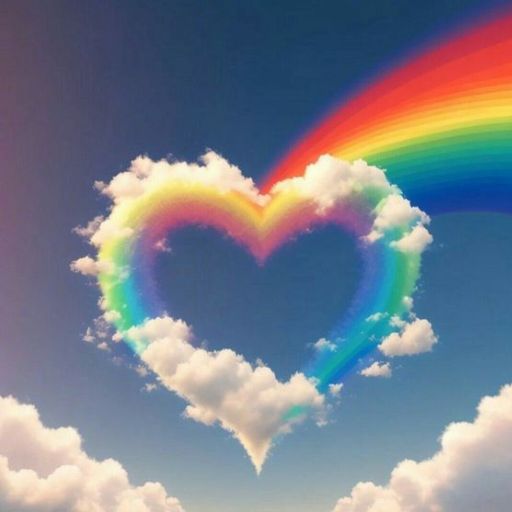 a heart shaped cloud with a rainbow in the sky