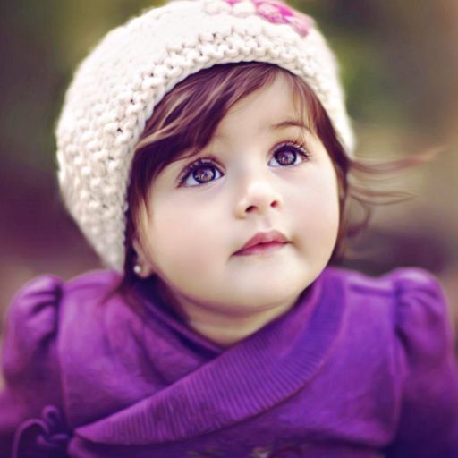 a little girl wearing a white knitted hat