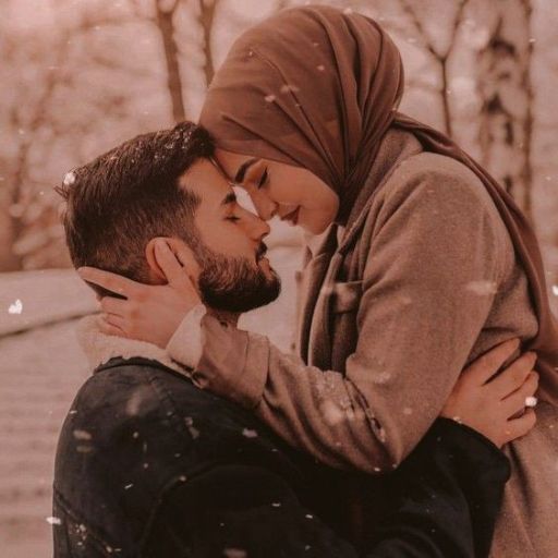 a man and a woman kissing in the snow