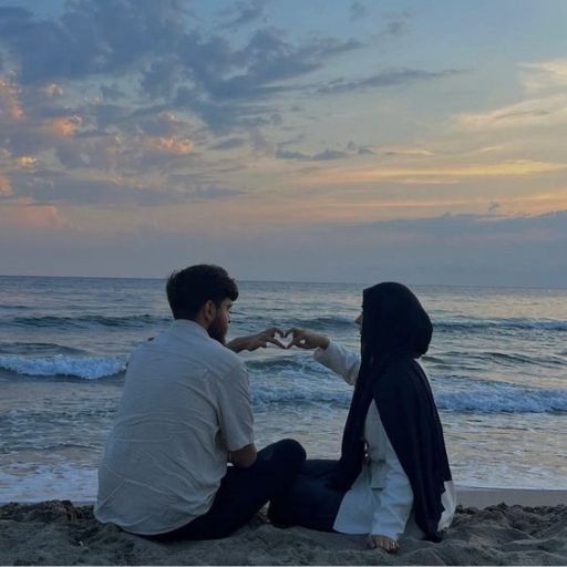 a man and a woman sitting on the beach