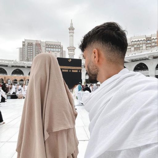 a man and a woman standing in front of a building