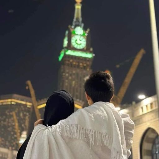 a man and a woman standing in front of a clock tower