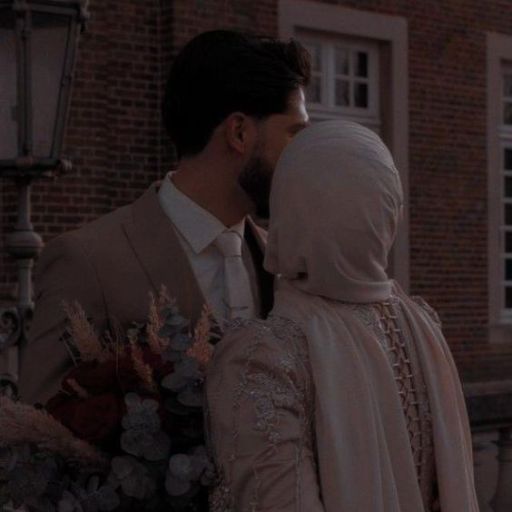 a man and a woman standing next to each other in front of a building