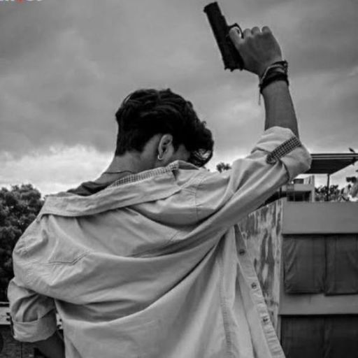 a man holding a gun up in the air