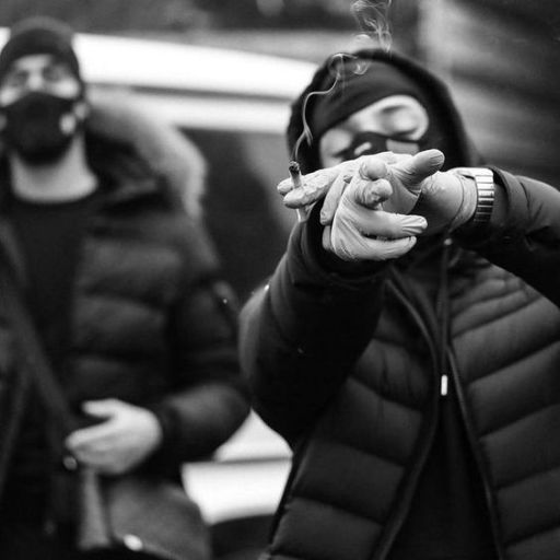 a man in a gas mask smoking a cigarette