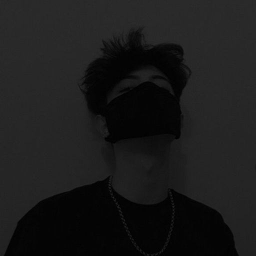 a man wearing a black mask in the dark