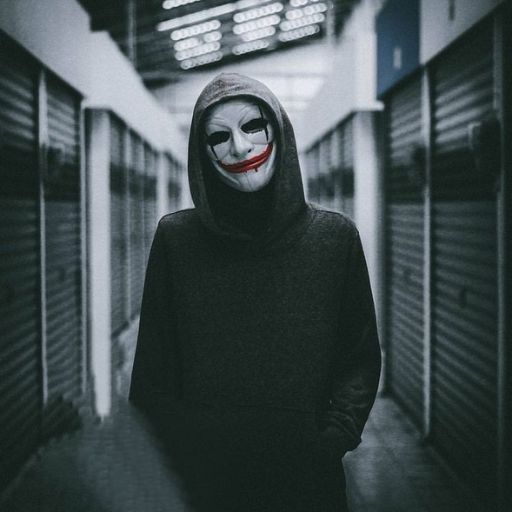 a person in a creepy mask standing in a hallway