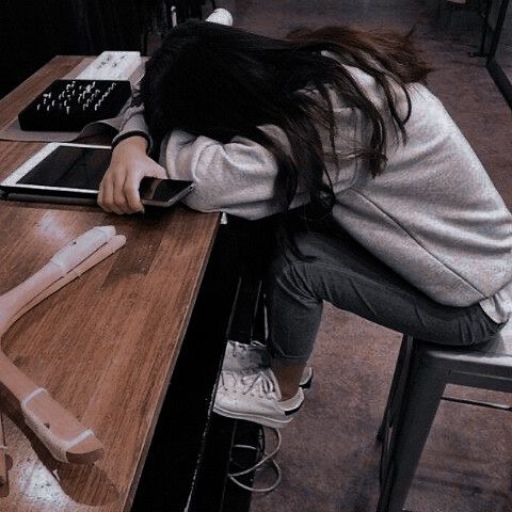 a person sitting at a table with a cell phone