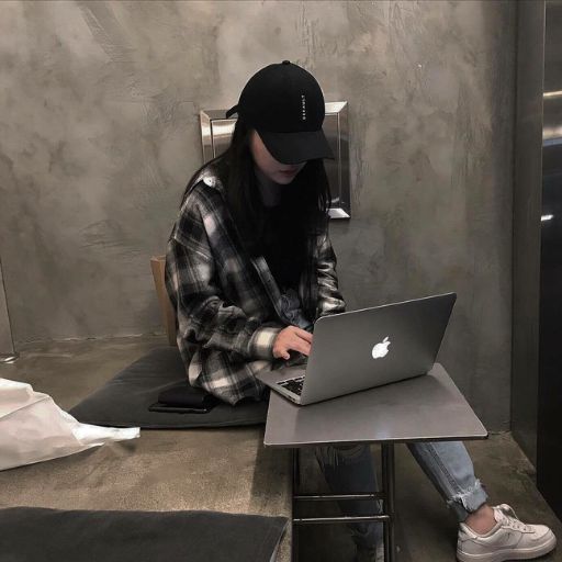 a person sitting at a table with a laptop