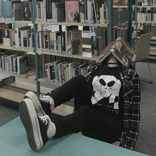 a person sitting on a table in a library