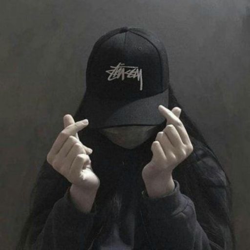 a person wearing a black hat with white writing on it