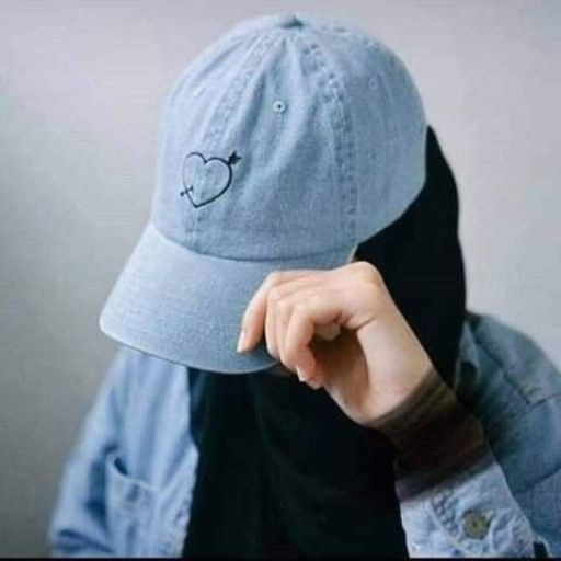 a person wearing a blue hat with a heart on it