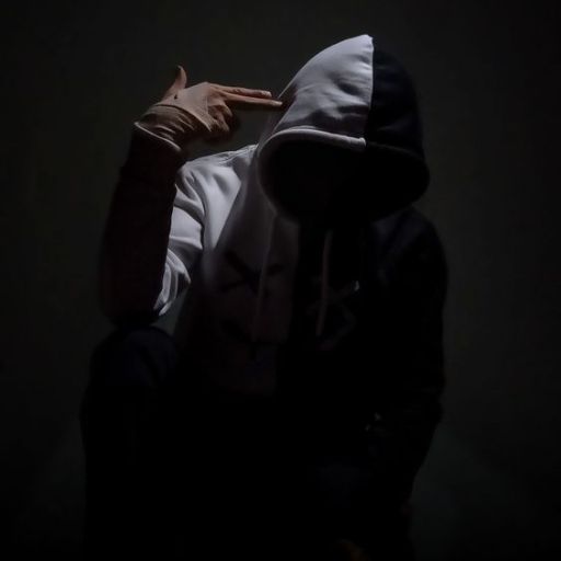 a person wearing a hoodie in the dark