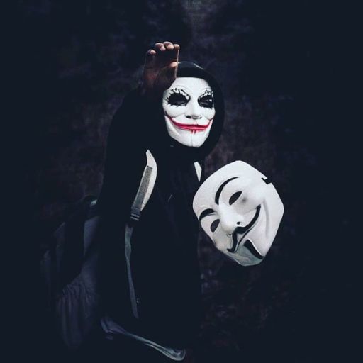 a person wearing a mask and holding a white mask