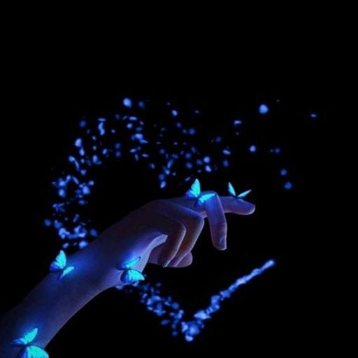 a person's hand holding a glowing object in the dark