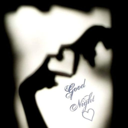 a shadow of a hand making a heart with the words good night