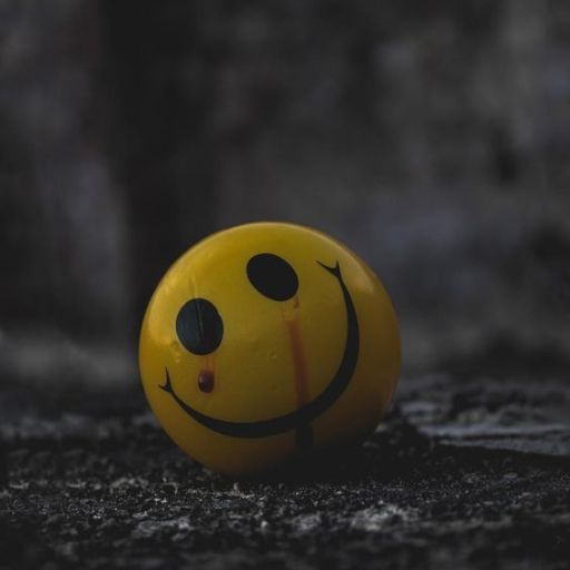 a smiley face painted on a yellow ball