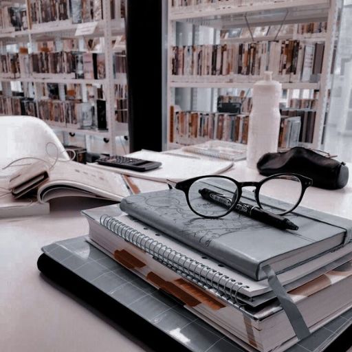 a stack of books sitting on top of a desk