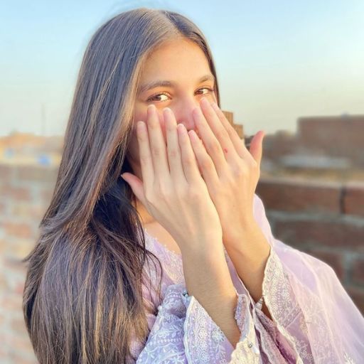 a woman covers her face with her hands