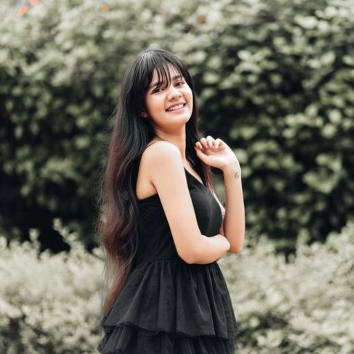 a woman in a black dress posing for a picture