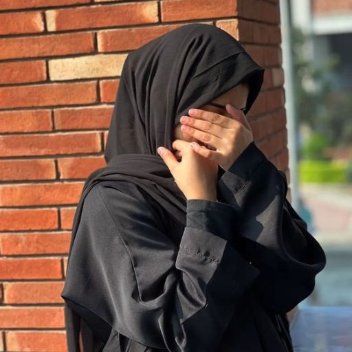 a woman in a black hijab covering her face