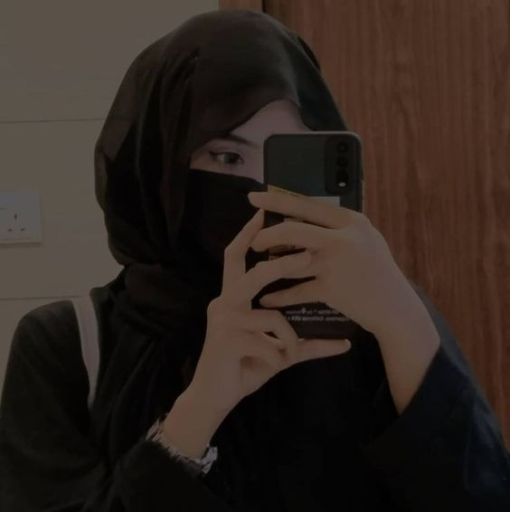 a woman in a black hijab holding a cell phone