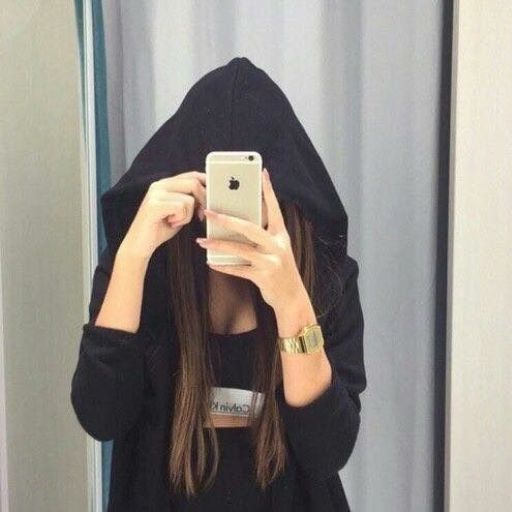 a woman in a black hoodie taking a selfie