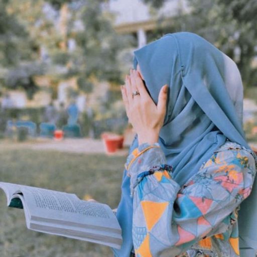 a woman in a headscarf reading a book